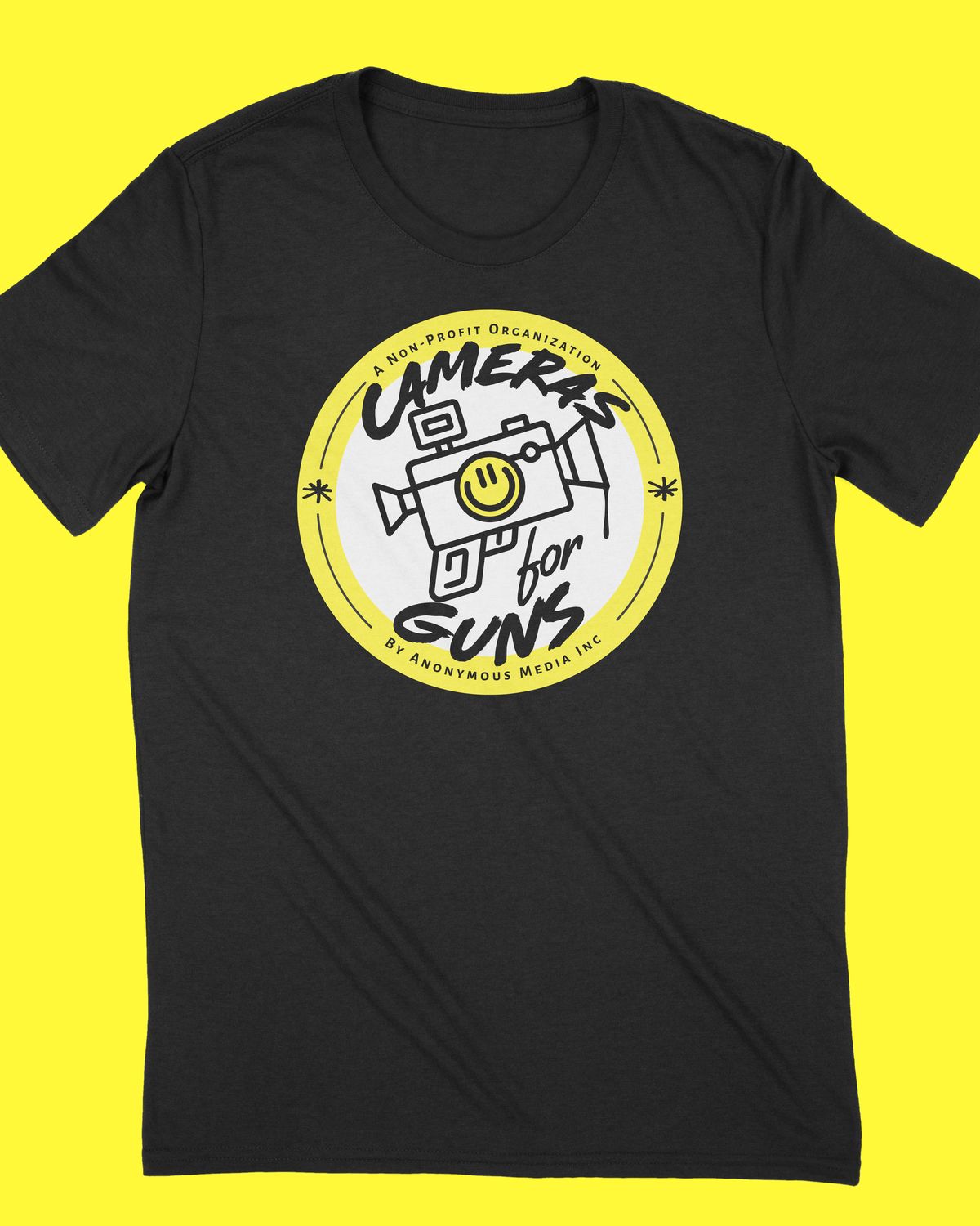 Black unisex t-shirt with the Cameras for Guns badge on the chest, on a yellow background